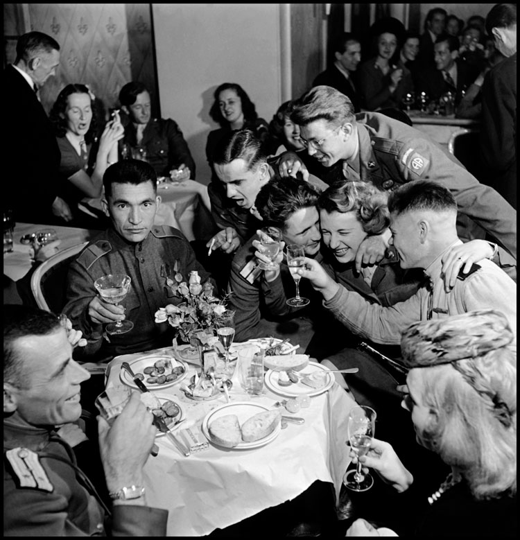Russian and American soldiers, part of the Allied occupation forces, at a multi-national party, Berlin, Germany, 1945 © Robert Capa © International Center of Photography/Magnum Photos