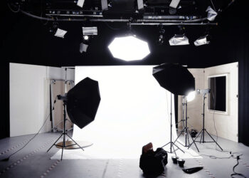 A photographic studio with a backdrop, lights, and softboxes. Original public domain image from Wikimedia Commons