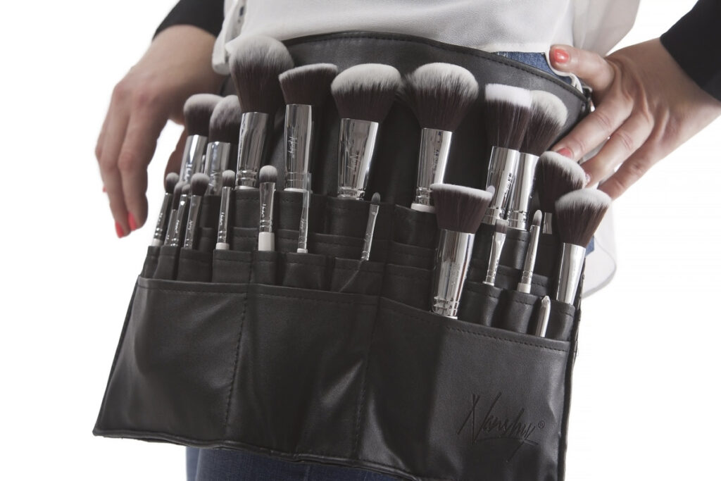 Makeup artist with brushes.