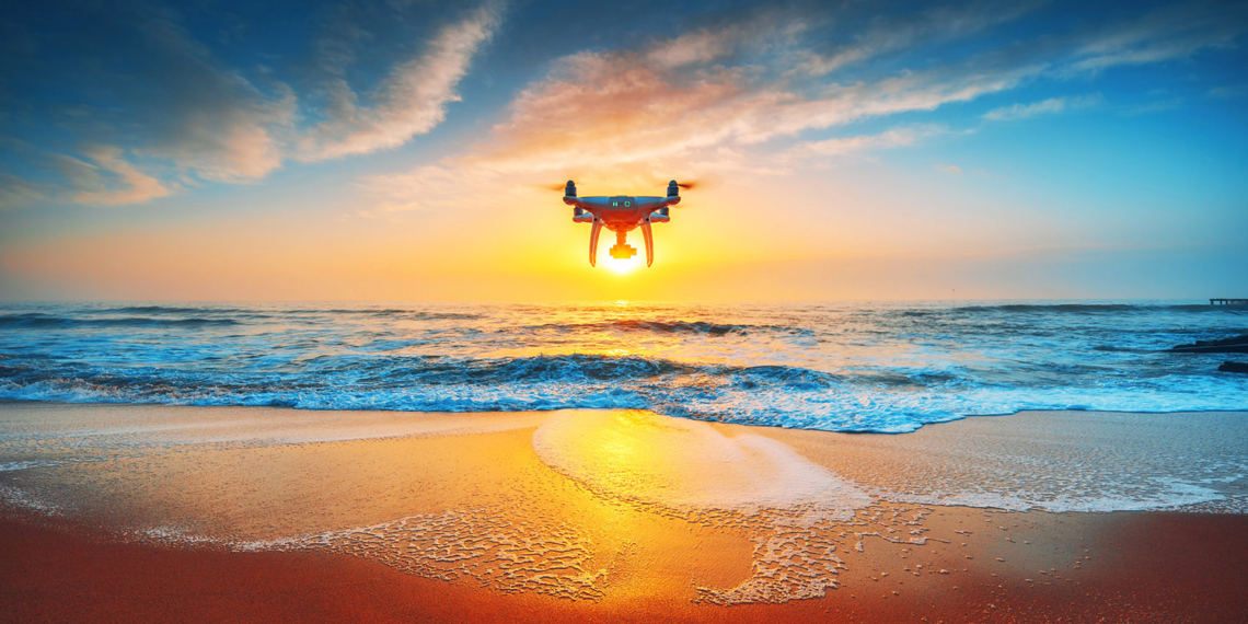 Beautiful morning over the sea and flying drone.