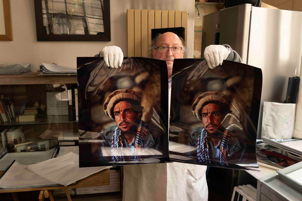 Roland Dufau con due stampe di "Commandant Massoud" di Reza Deghati. A sinistra la stampa Cibachrome